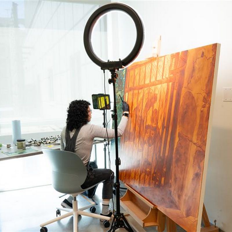 woman painting on canvas